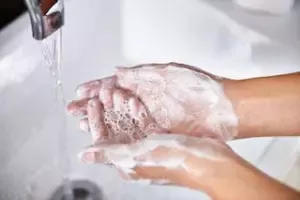 Washing hands with soap in sink