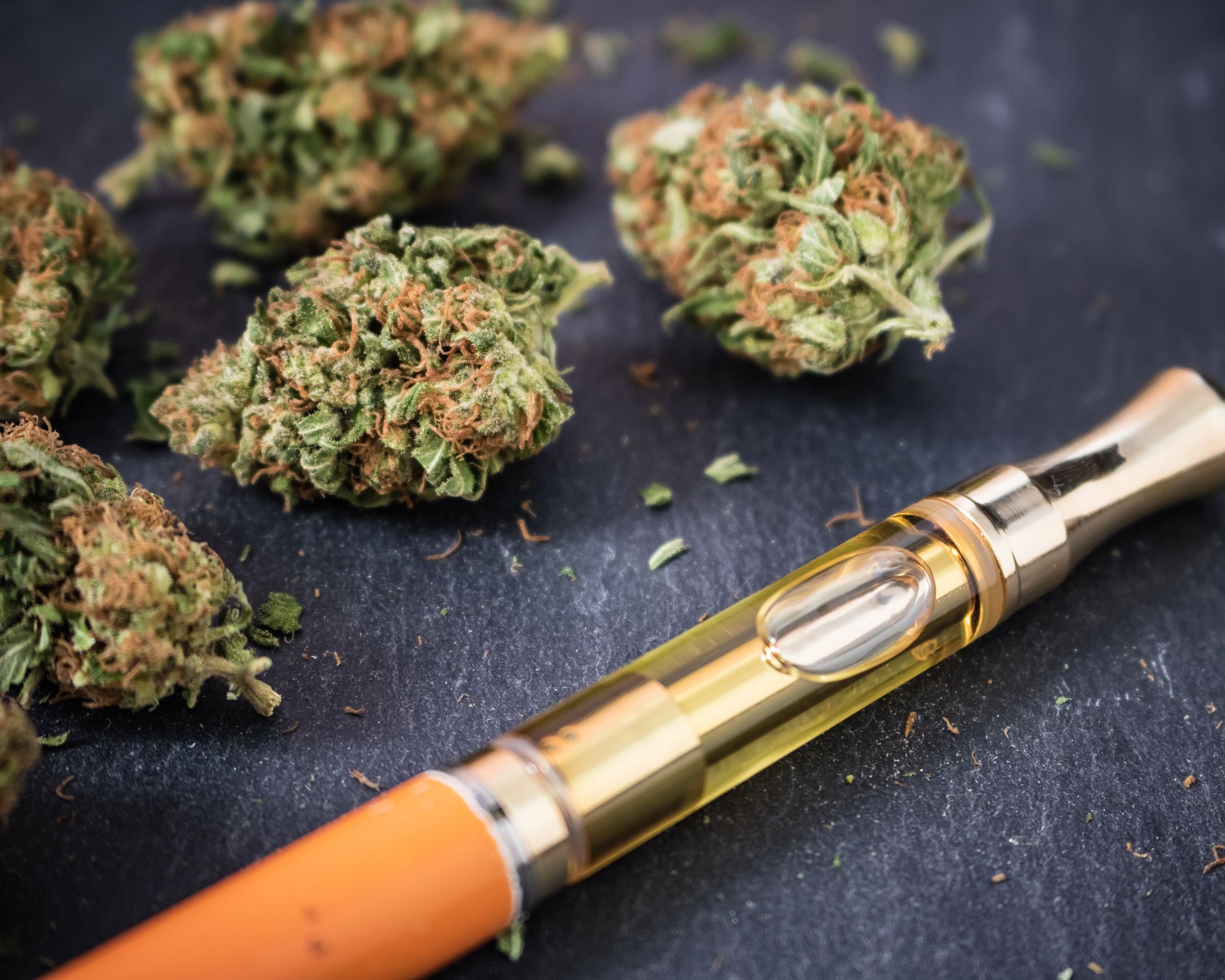 Cannabis buds with a THC oil concentrate filled vape pen