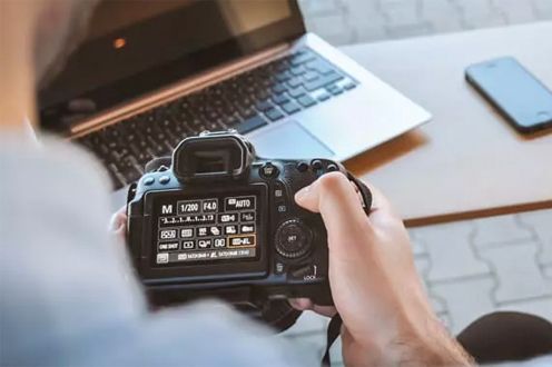 <p>Photo of a hand holding a camera</p>
