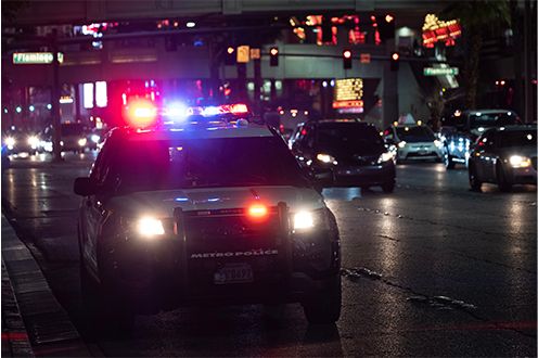 <p>Photo of a police car with emergency lights flashing</p>
