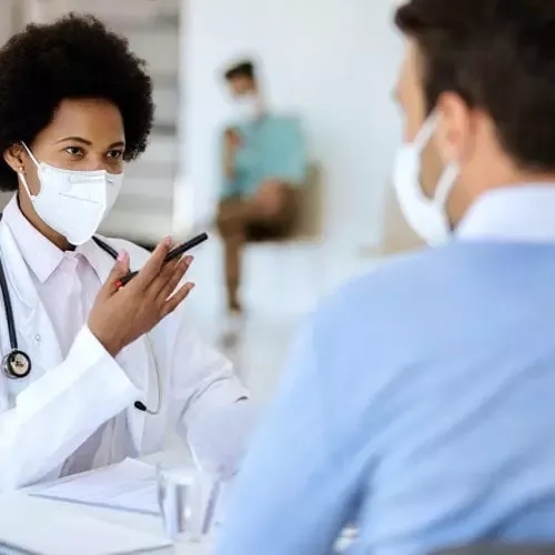 Doctor and patient wearing masks