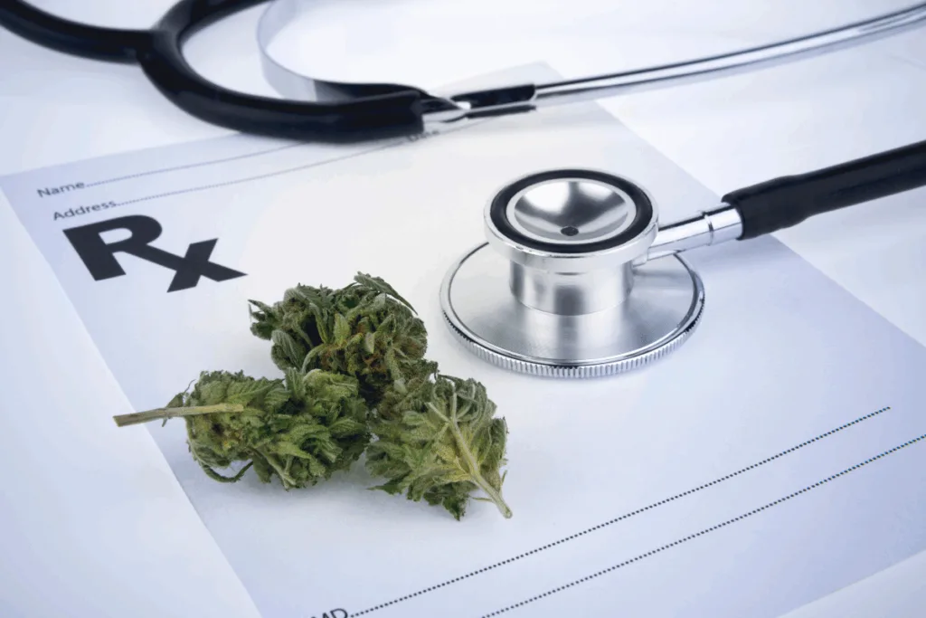 A stethoscope and a cannabis bud rest on a blank prescription form, symbolizing medical marijuana.