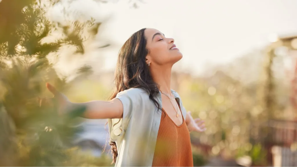 Woman feeling free with arms spread out after a successful cannabis tolerance break