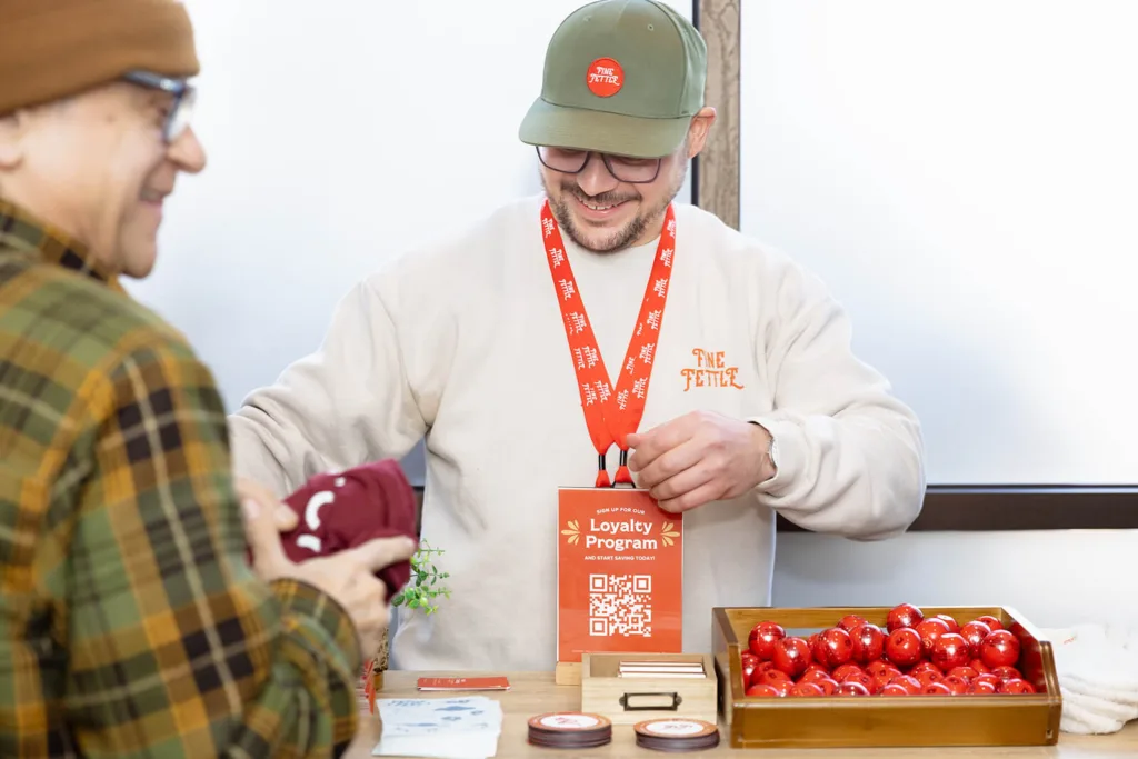 budtender standing behind loyalty program display