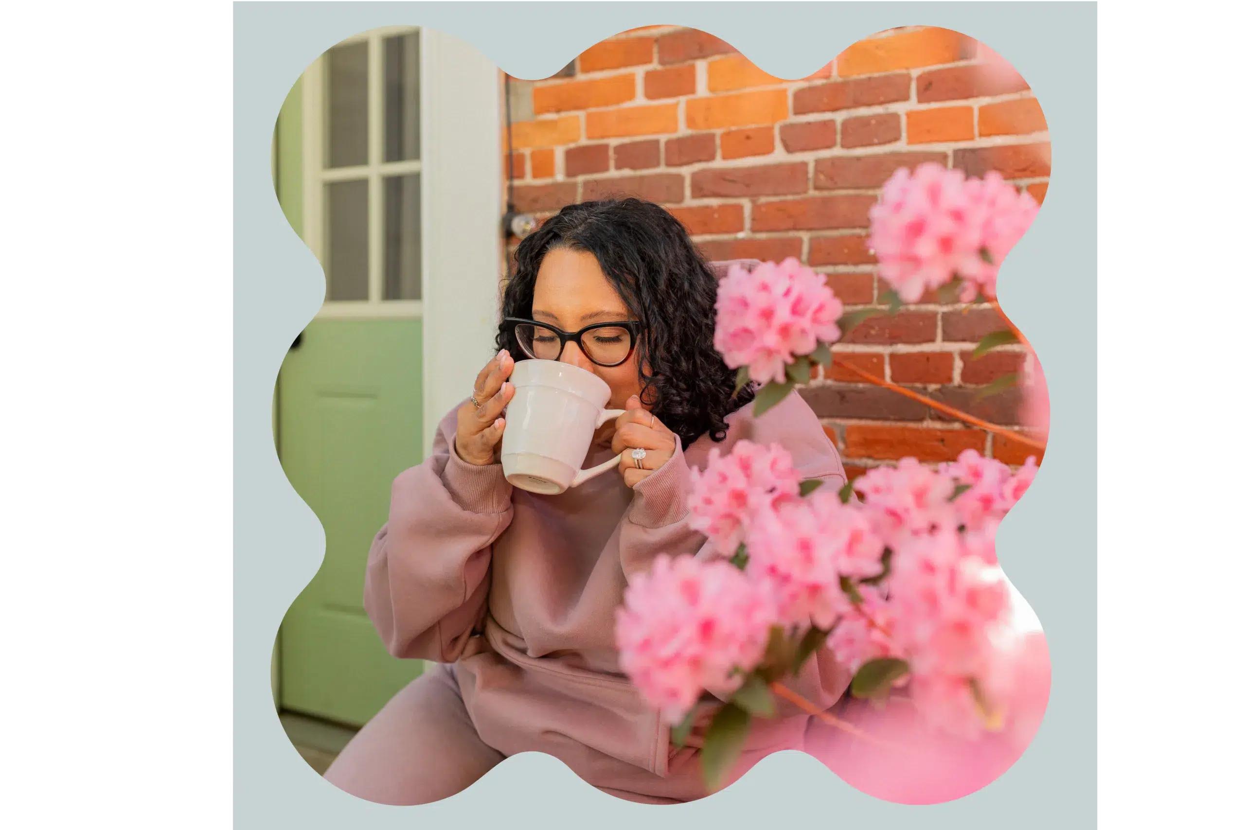 Woman Sipping Coffee Near Pink Flowers
