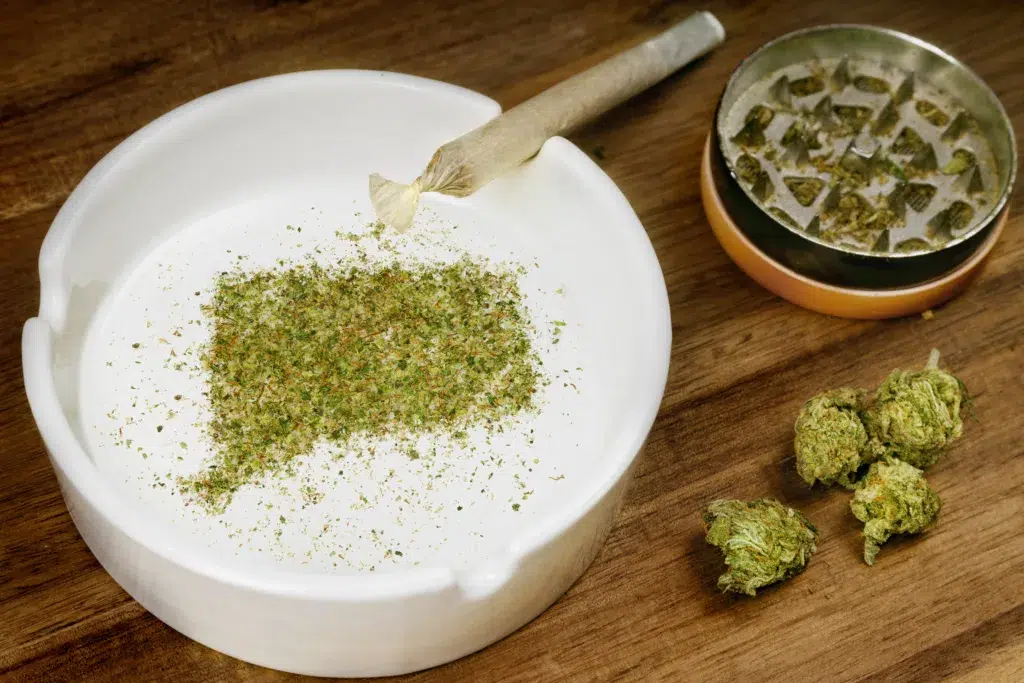 Ground weed in the shape of Connecticut with a joint.